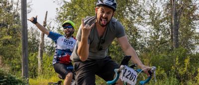 Two riders get psyched up by throwing some hang loose signs before plunging headlong into a volcano