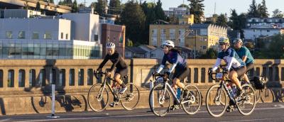 Four STP riders cross the University Bridge in Seattle.