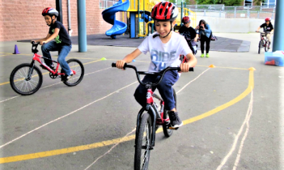 A child learns bike safety lessons in their Let's Go class