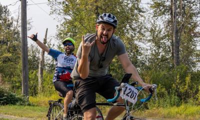 Two riders get psyched up by throwing some hang loose signs before plunging headlong into a volcano